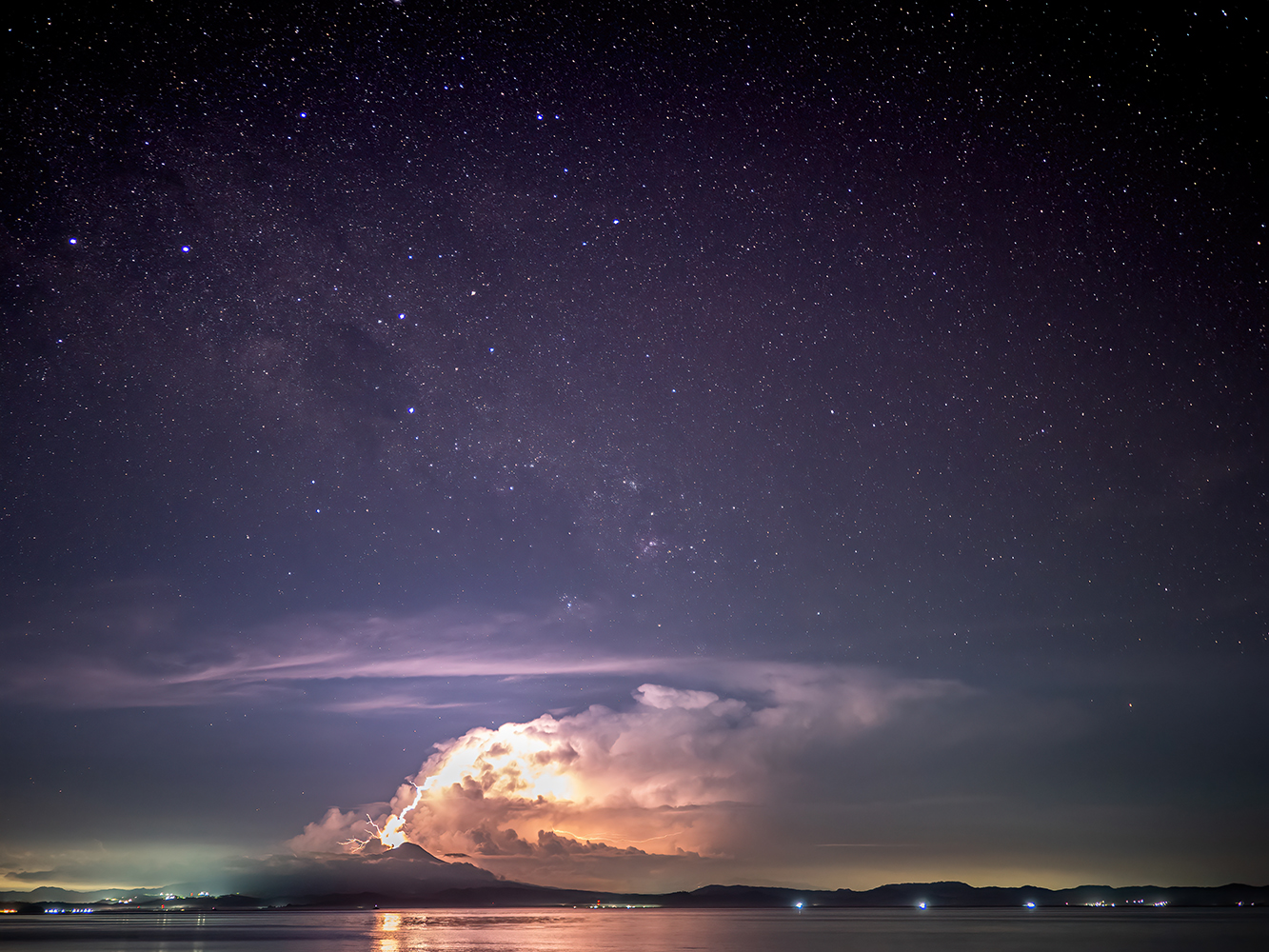 Starry sky and lightning on Bangka Island, North Sulawesi.